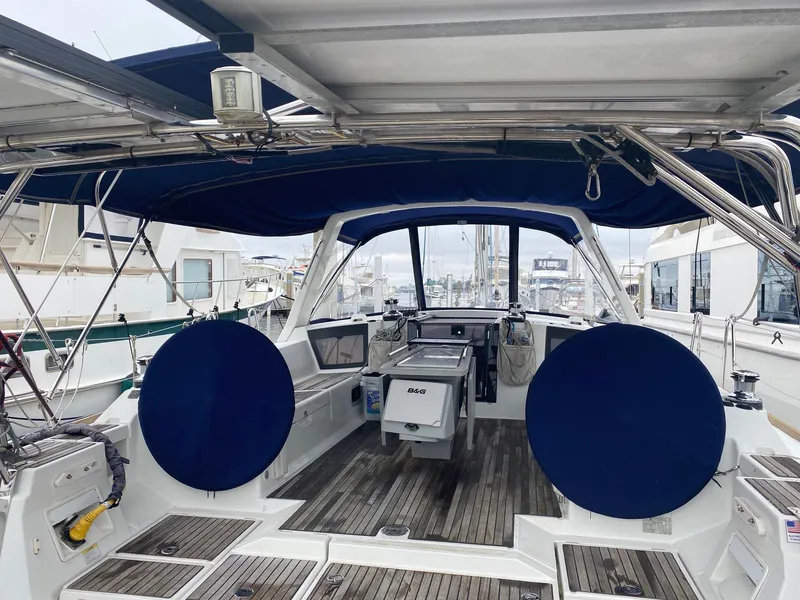 Slide: The Image of Beneteau Oceanis 45 sailboat cockpit, 2014 model, featuring blue covers and wooden flooring. - 7