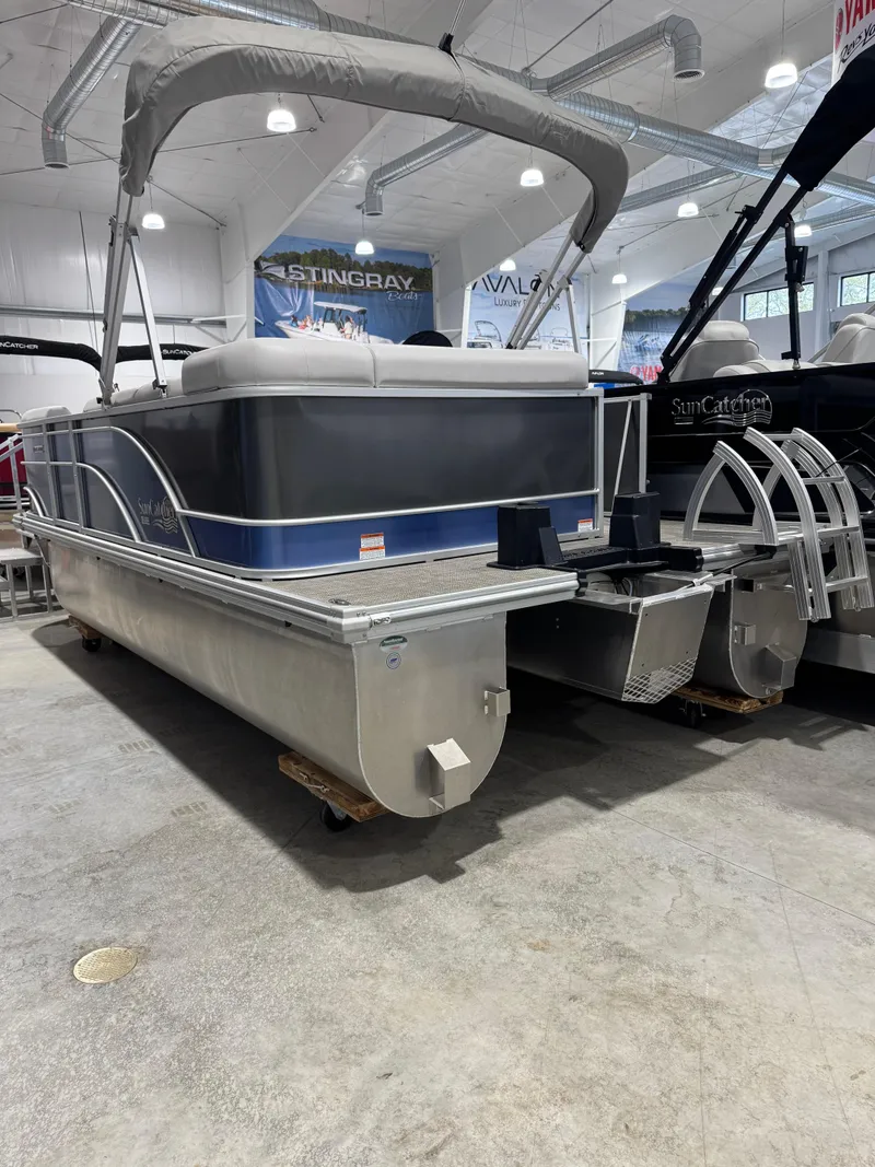 Slide: The Image of 2024 G3 Select 18C pontoon boat displayed indoors, featuring a sleek design and sturdy construction. - 3