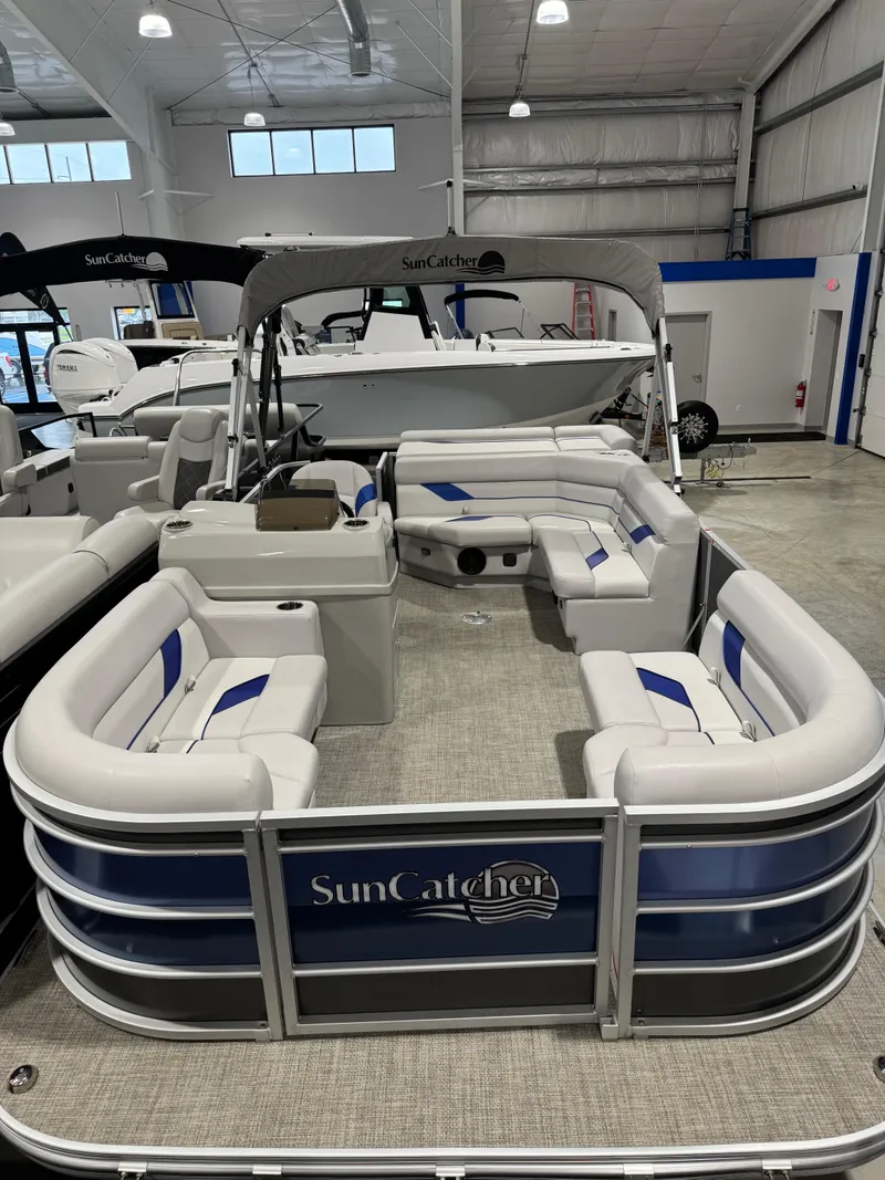 Slide: The Image of 2024 G3 Select 18C pontoon boat with spacious seating in a showroom. - 5