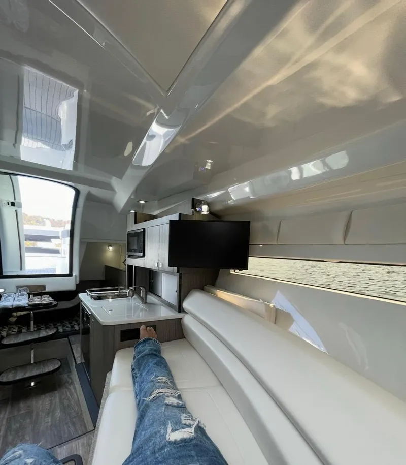 Slide: The Image of Interior of 2022 Monterey 295 Sport Yacht, featuring modern design and comfortable seating. - 11