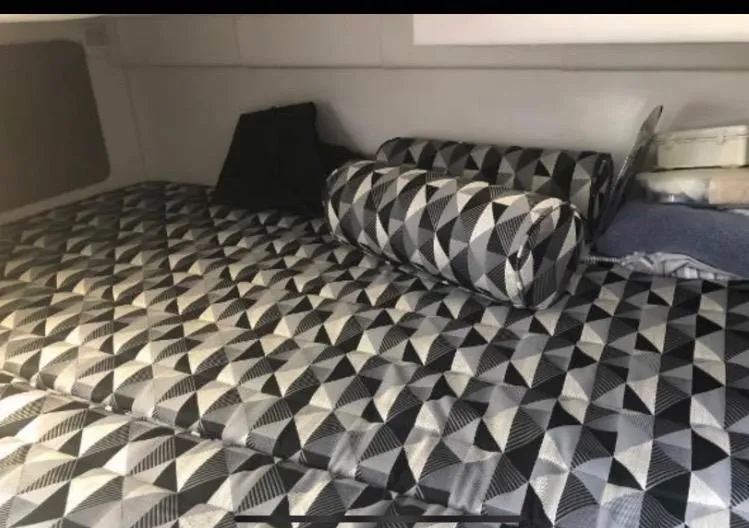 Slide: The Image of Interior cabin of 2022 Monterey 295 Sport Yacht with geometric-patterned bedding. - 15