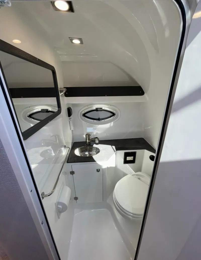 Slide: The Image of 2022 Monterey 295 Sport Yacht bathroom with modern fixtures and compact design. - 16