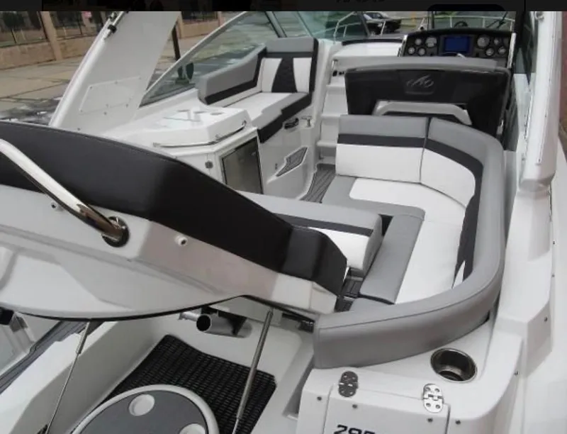 Slide: The Image of 2022 Monterey 295 Sport Yacht interior with sleek seating and modern dashboard. - 19