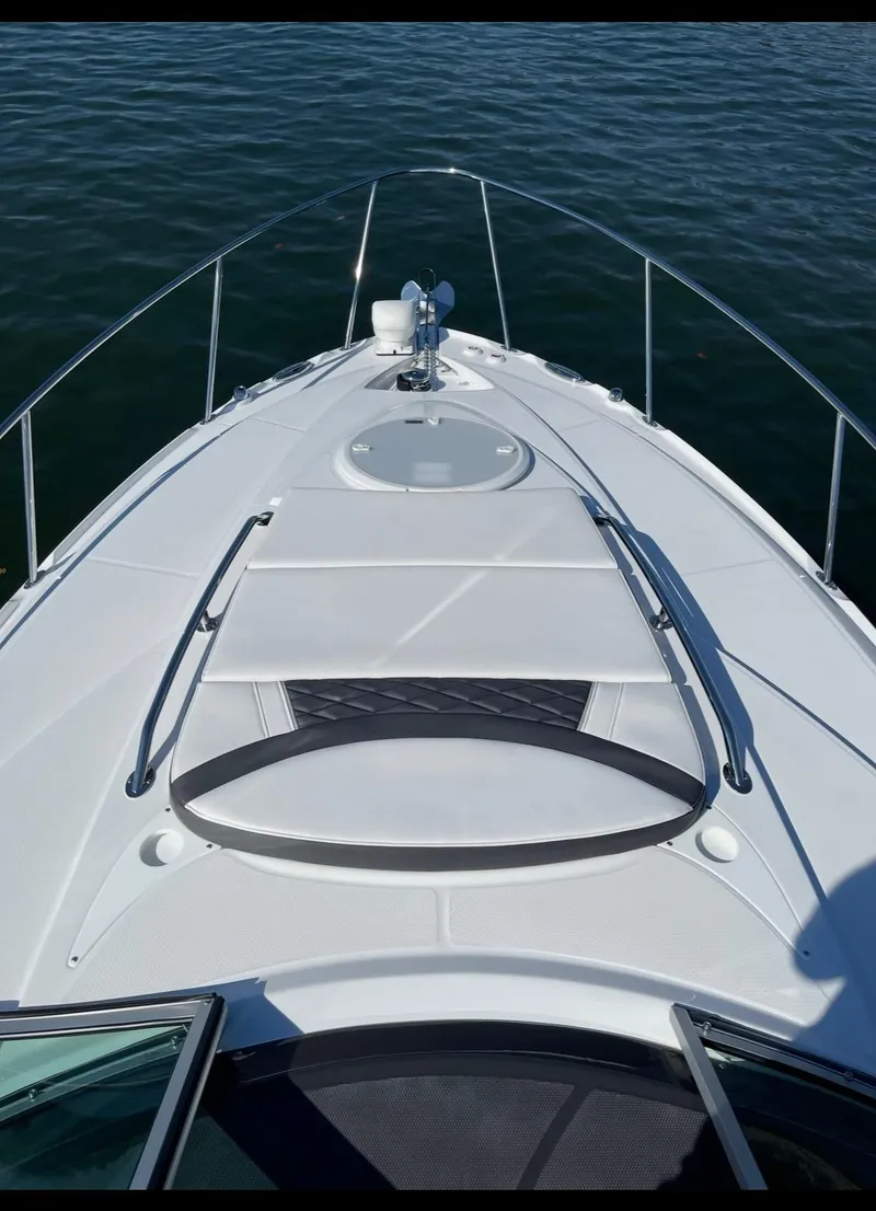 Slide: The Image of 2022 Monterey 295 Sport Yacht bow view on water. - 3