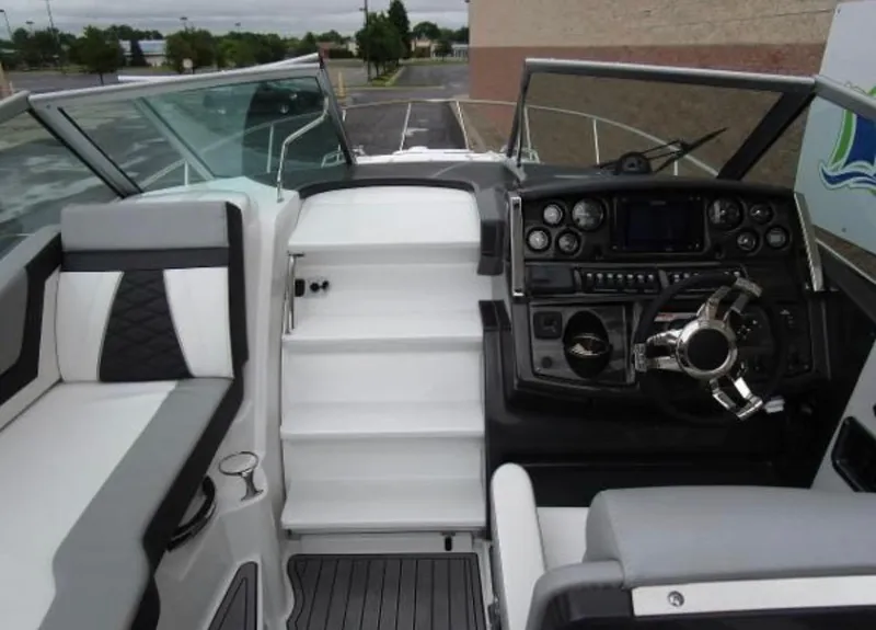 Slide: The Image of 2022 Monterey 295 Sport Yacht cockpit with modern controls and seating. - 6