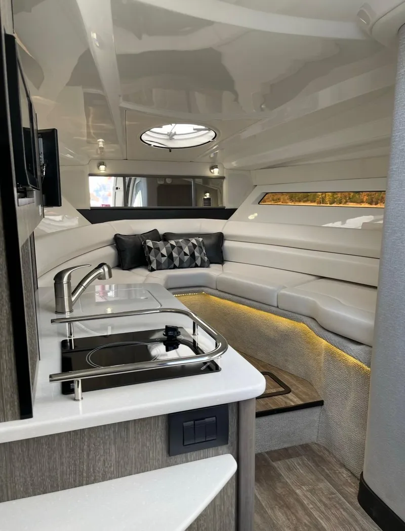 Slide: The Image of Luxurious interior of 2022 Monterey 295 Sport Yacht with modern amenities and elegant seating. - 8