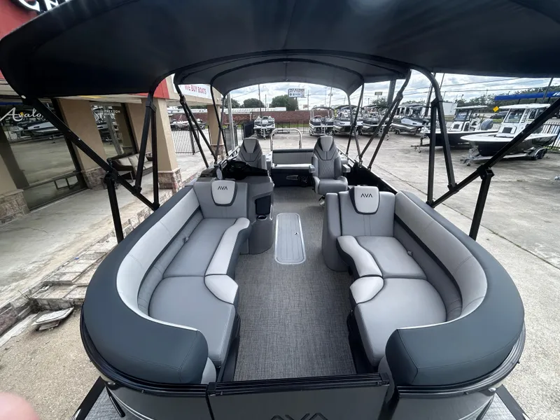 Slide: The Image of 2025 Avalon LSZ VRB23T DX pontoon boat with spacious seating and canopy, displayed outdoors. - 11