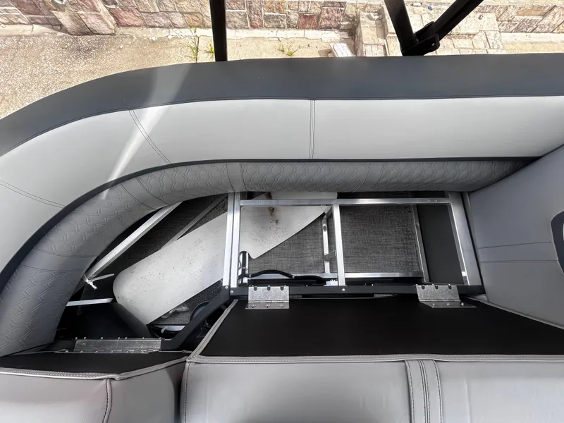 Slide: The Image of Avalon LSZ VRB23T DX 2025 boat interior with gray seating and storage compartment. - 12