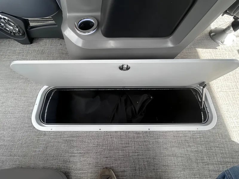 Slide: The Image of Open storage compartment in 2025 Avalon LSZ VRB23T DX boat interior. - 14