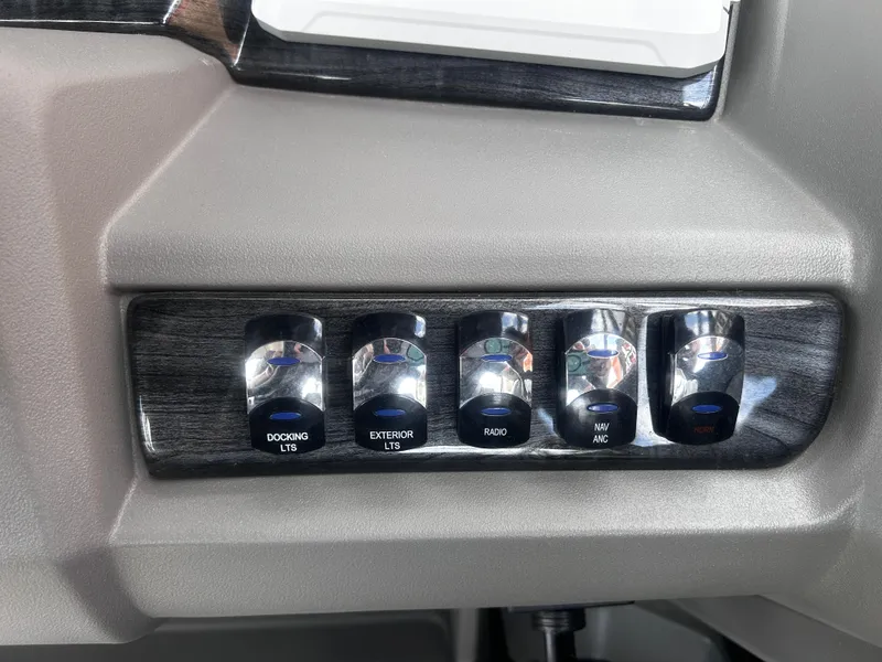 Slide: The Image of Control panel with switches for docking lights, exterior lights, radio, navigation, and horn in Avalon LSZ VRB23T DX. - 19