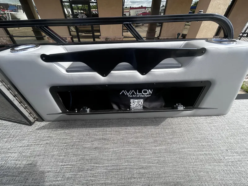 Slide: The Image of 2025 Avalon LSZ VRB23T DX pontoon interior with storage compartment and branding. - 22