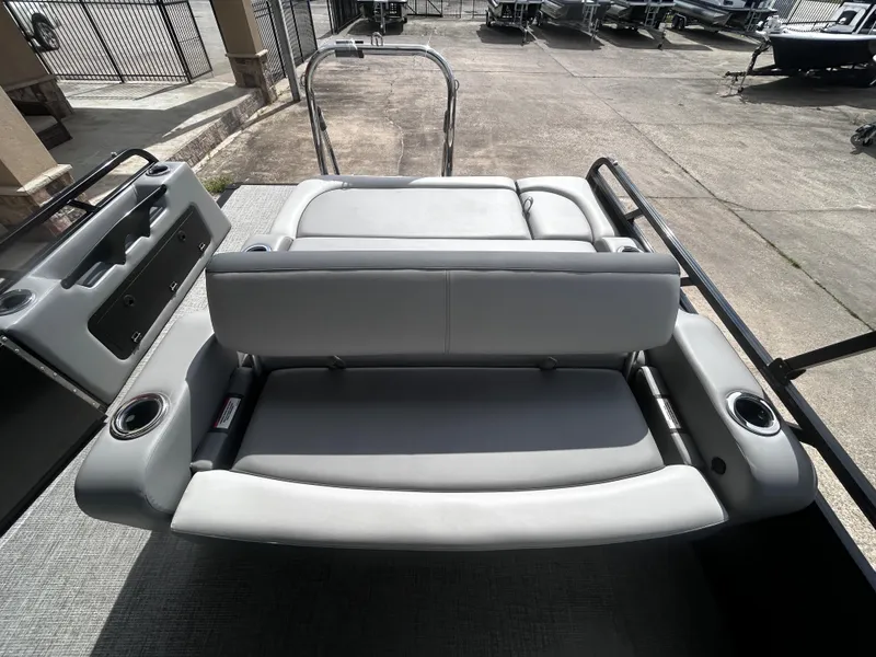 Slide: The Image of 2025 Avalon LSZ VRB23T DX boat interior with gray seating and cup holders. - 23