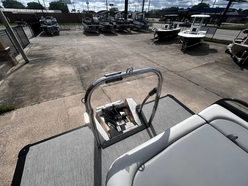 Slide: The Image of 2025 Avalon LSZ VRB23T DX pontoon boat at a dealership, surrounded by other boats. - 25
