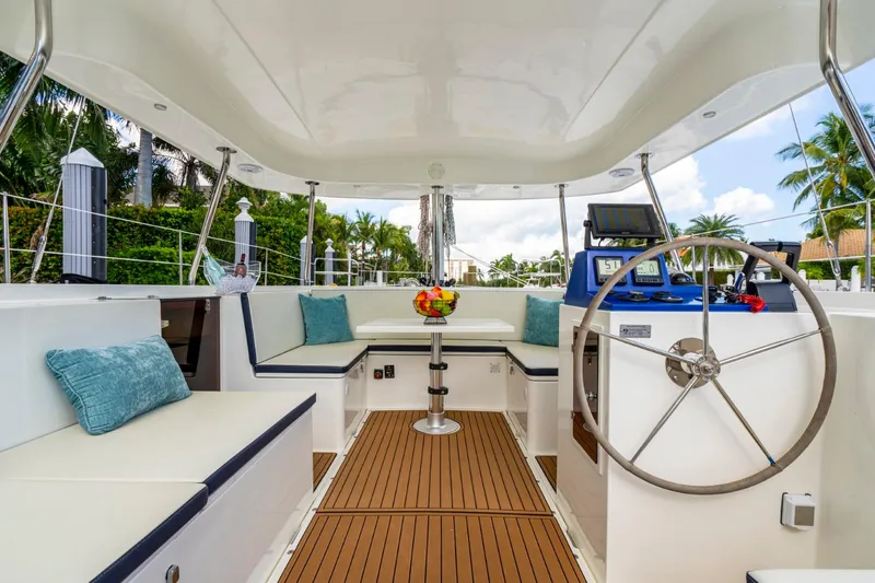 Slide: The Image of Luxurious Smart Cat M280 Power yacht interior with seating, steering wheel, and tropical view. - 19