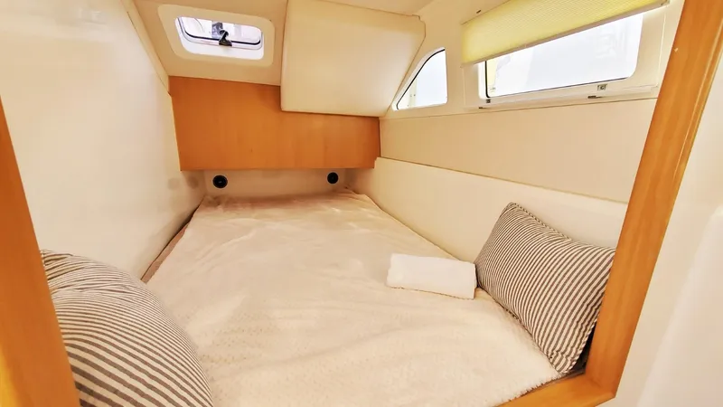 Slide: The Image of Cozy cabin interior of 2025 Smart Cat M280 Power with striped pillows and natural light. - 26