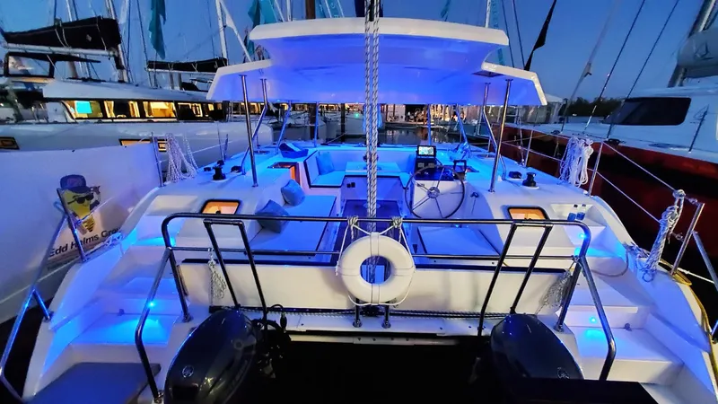 Slide: The Image of Modern Smart Cat M280 Power yacht with blue LED lights, 2025 model, docked at night. - 35