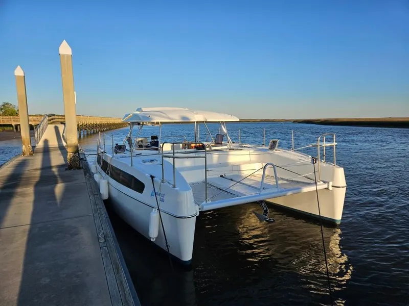 Slide: The Image of Modern 2025 Smart Cat M280 Power catamaran docked at a serene waterfront. - 5