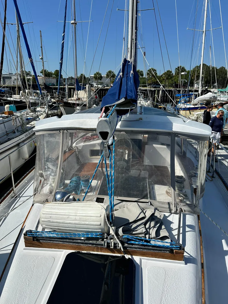 Slide: The Image of 1981 Kelly Peterson 44 sailboat docked in a marina, clear day, blue skies. - 14