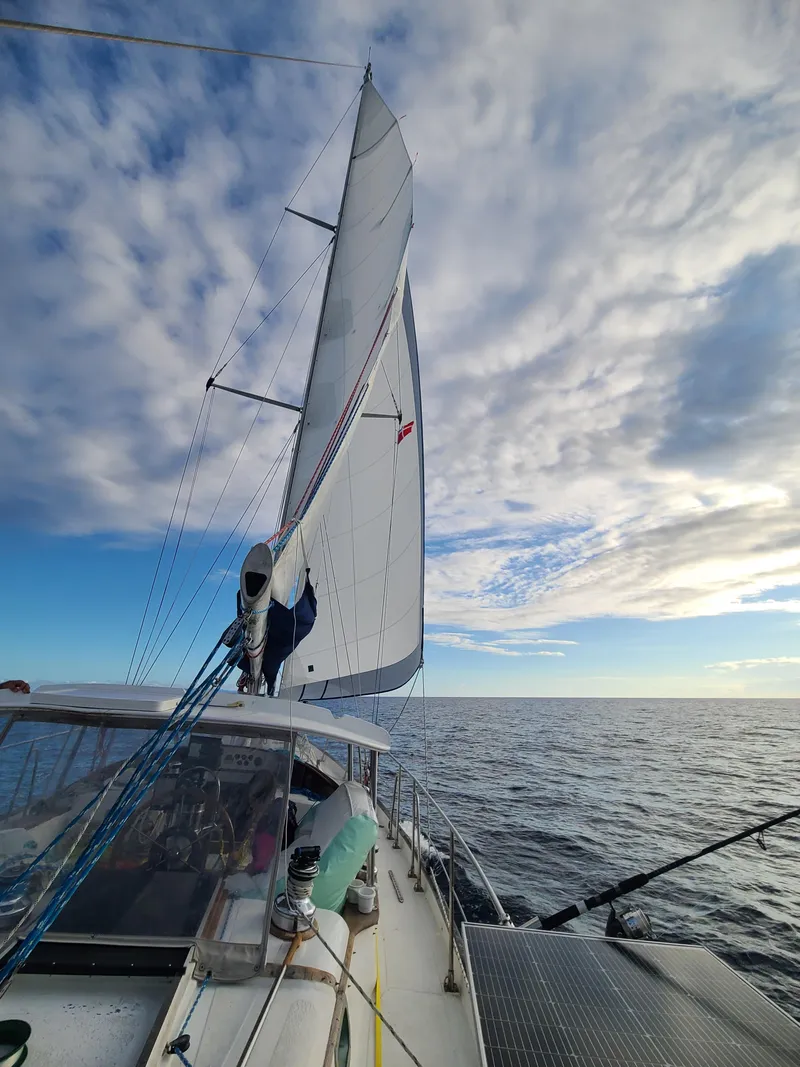 Slide: The Image of Sailing on a 1981 Kelly Peterson 44 yacht under a partly cloudy sky. - 16