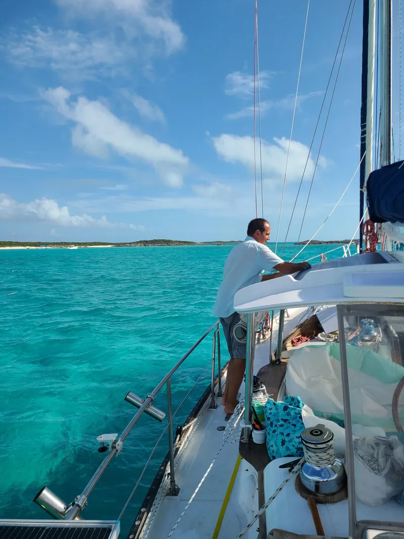 Slide: The Image of Man sailing on a 1981 Kelly Peterson 44 yacht in clear turquoise waters. - 17