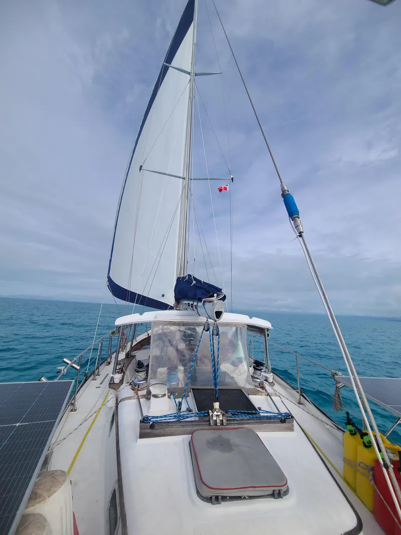 Slide: The Image of Sailing on a 1981 Kelly Peterson 44 yacht with open sails on a clear ocean day. - 18