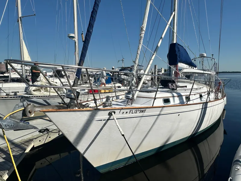 Slide: The Image of Sailboat docked at marina, 1981 Kelly Peterson 44 model, clear blue sky. - 2