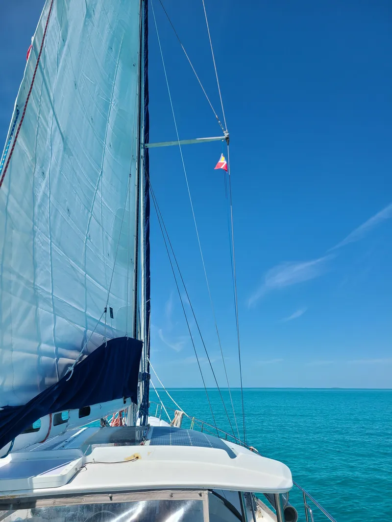 Slide: The Image of Sailing on a 1981 Kelly Peterson 44 yacht under clear blue skies and calm sea. - 20
