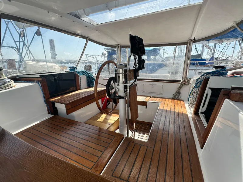 Slide: The Image of Interior of 1981 Kelly Peterson 44 sailboat with wooden flooring and steering wheel. - 21