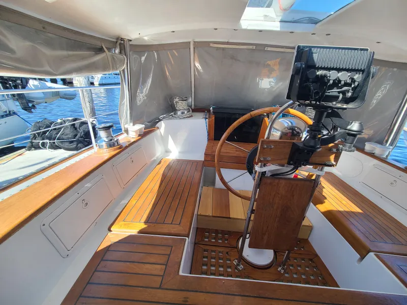 Slide: The Image of Interior of 1981 Kelly Peterson 44 sailboat with wooden seating and steering wheel. - 22