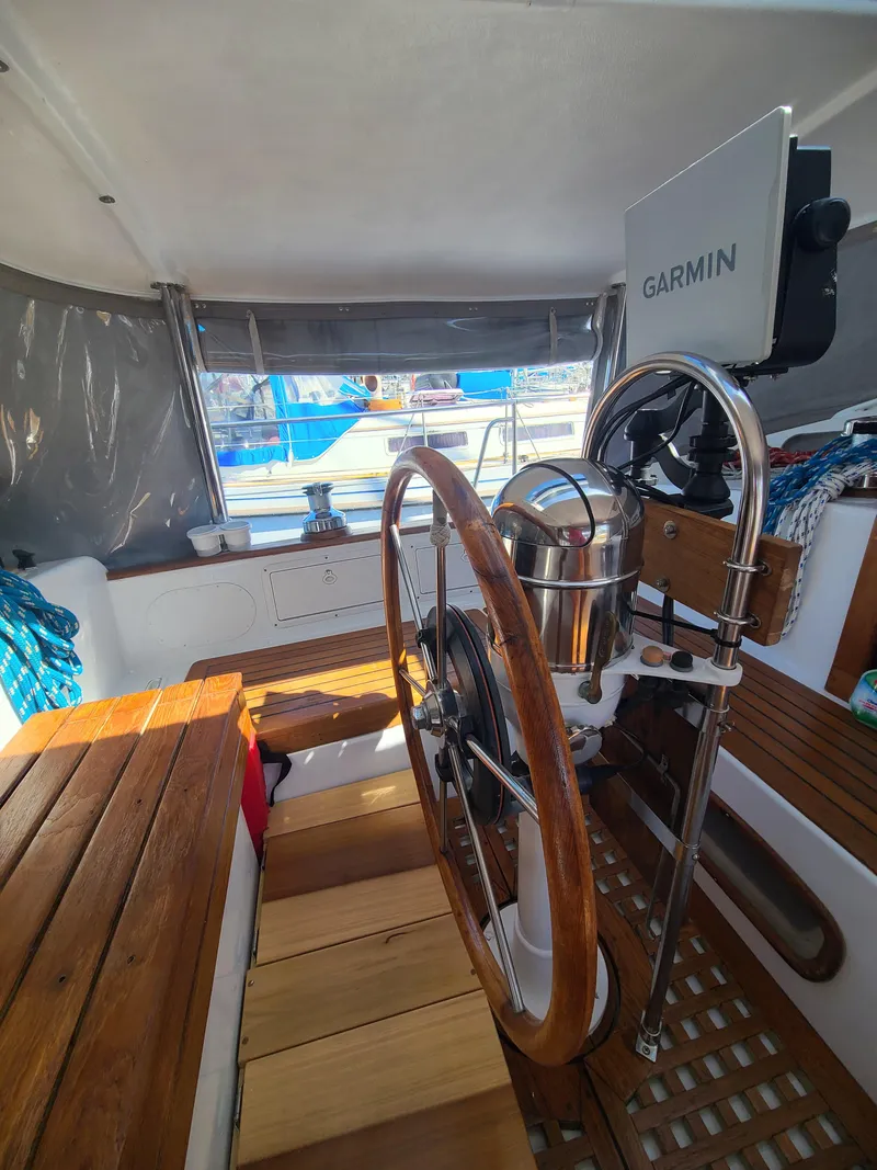 Slide: The Image of Interior of 1981 Kelly Peterson 44 sailboat with wooden steering wheel and Garmin navigation system. - 26
