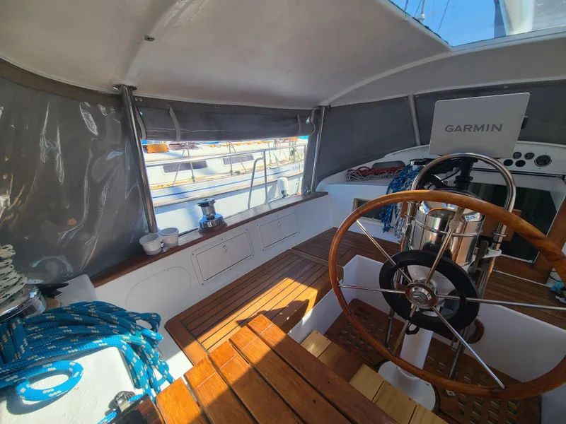 Slide: The Image of Cockpit of 1981 Kelly Peterson 44 sailboat with wooden wheel and Garmin navigation system. - 29