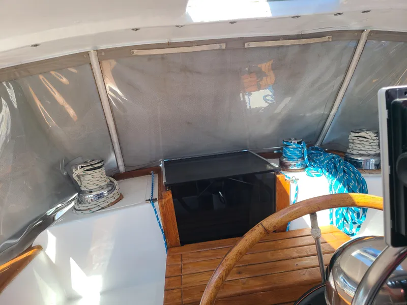 Slide: The Image of Interior of 1981 Kelly Peterson 44 sailboat with wooden steering wheel and ropes. - 30