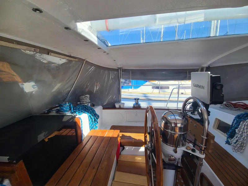Slide: The Image of Interior of 1981 Kelly Peterson 44 sailboat cockpit with wooden benches and navigation equipment. - 31