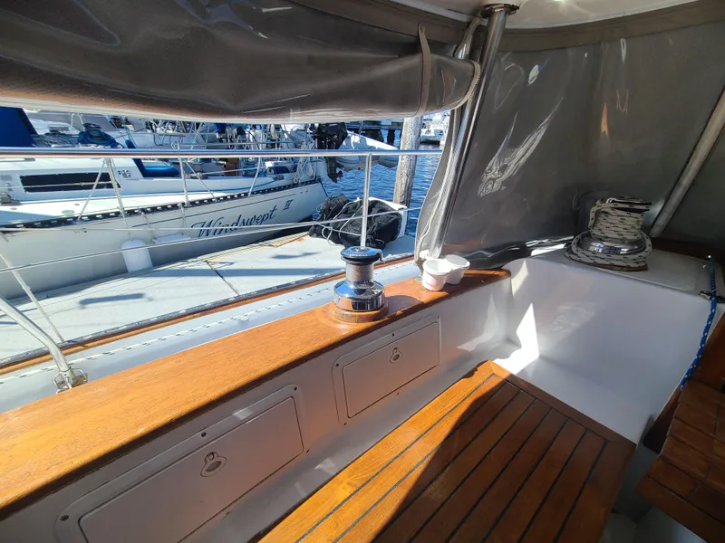 Slide: The Image of Cockpit of 1981 Kelly Peterson 44 sailboat with wooden seating and winch. - 32