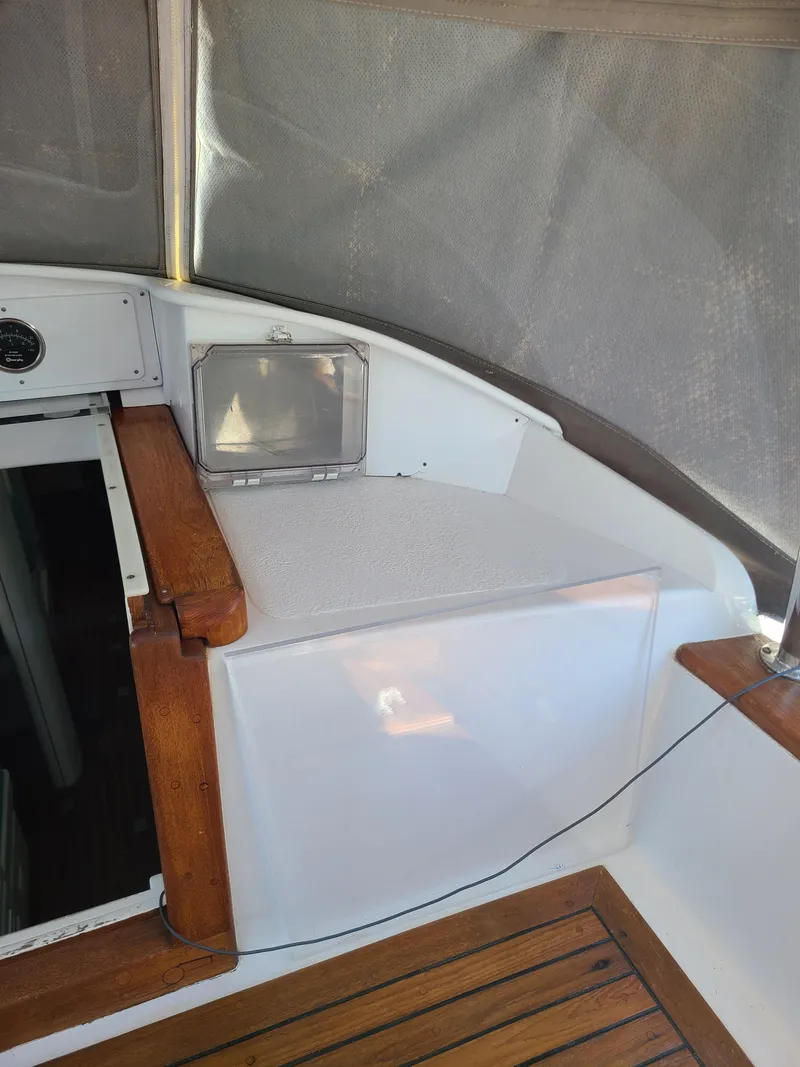 Slide: The Image of Interior of 1981 Kelly Peterson 44 sailboat with wooden and white seating area. - 33