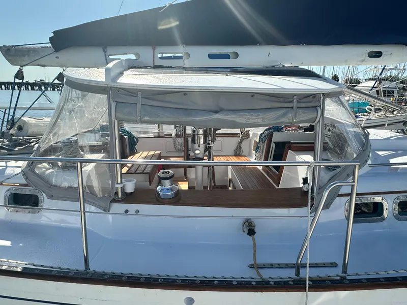 Slide: The Image of 1981 Kelly Peterson 44 sailboat cockpit with clear canopy and wooden seating. - 4