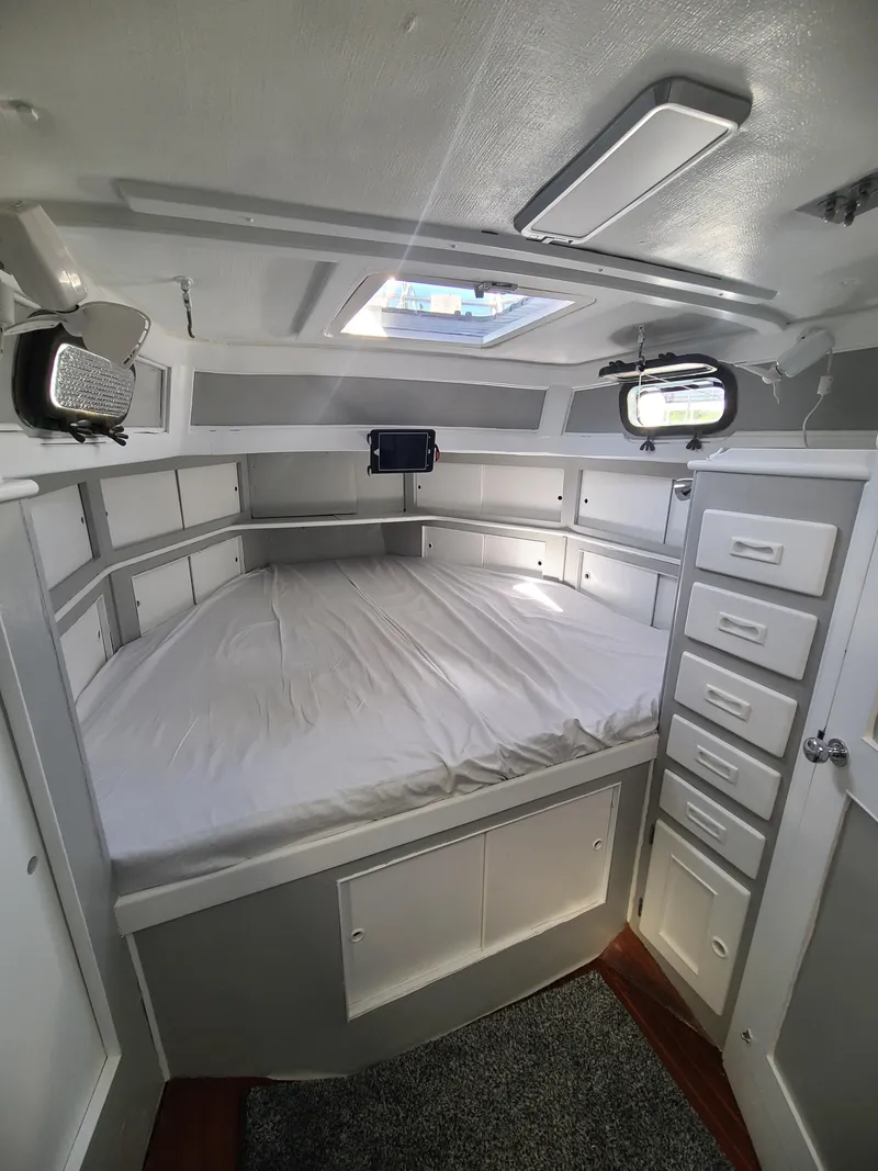 Slide: The Image of Cozy cabin interior of 1981 Kelly Peterson 44 sailboat with bed and storage. - 44