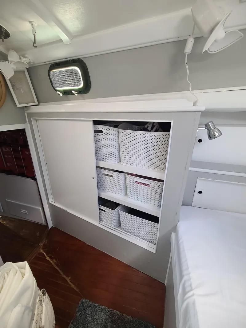 Slide: The Image of Interior of 1981 Kelly Peterson 44 sailboat with organized storage shelves and wicker baskets. - 49