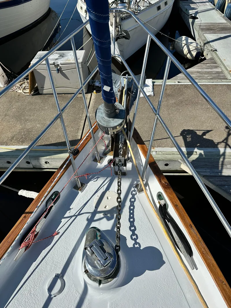 Slide: The Image of Bow of 1981 Kelly Peterson 44 sailboat with anchor chain and dock view. - 6