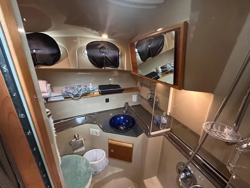 Slide: The Image of 2014 Cutwater C-30 Sedan bathroom with modern fixtures and blue glass sink. - 12