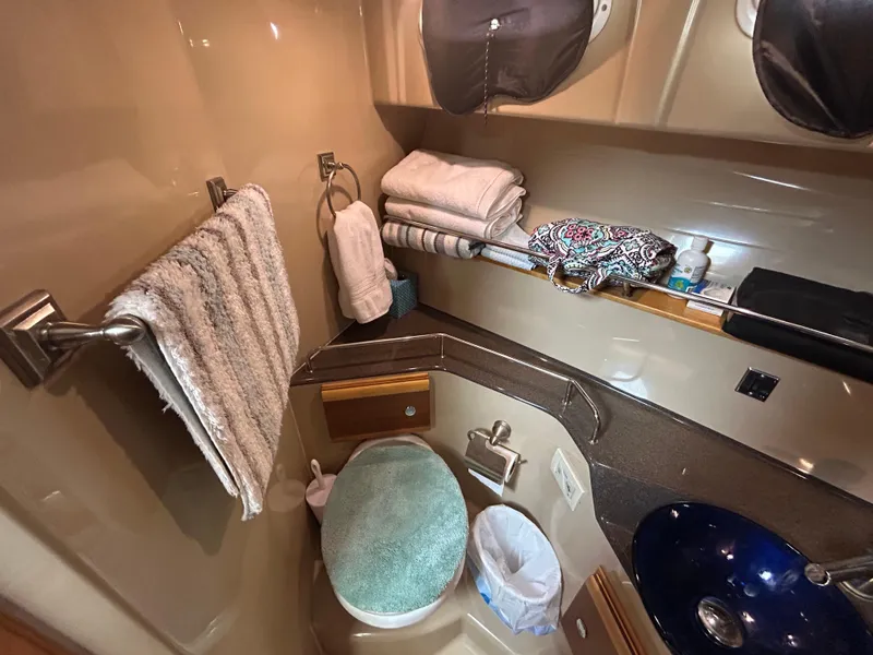 Slide: The Image of 2014 Cutwater C-30 Sedan bathroom with towels, sink, and storage. - 13