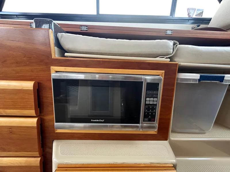 Slide: The Image of Microwave in 2014 Cutwater C-30 Sedan boat interior, wooden cabinetry. - 15