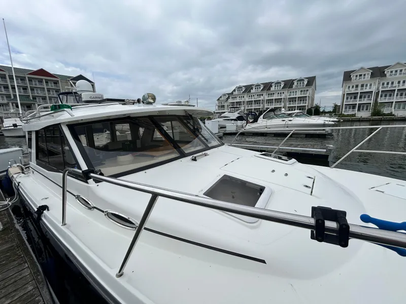 Slide: The Image of 2014 Cutwater C-30 Sedan docked at marina with overcast sky. - 21