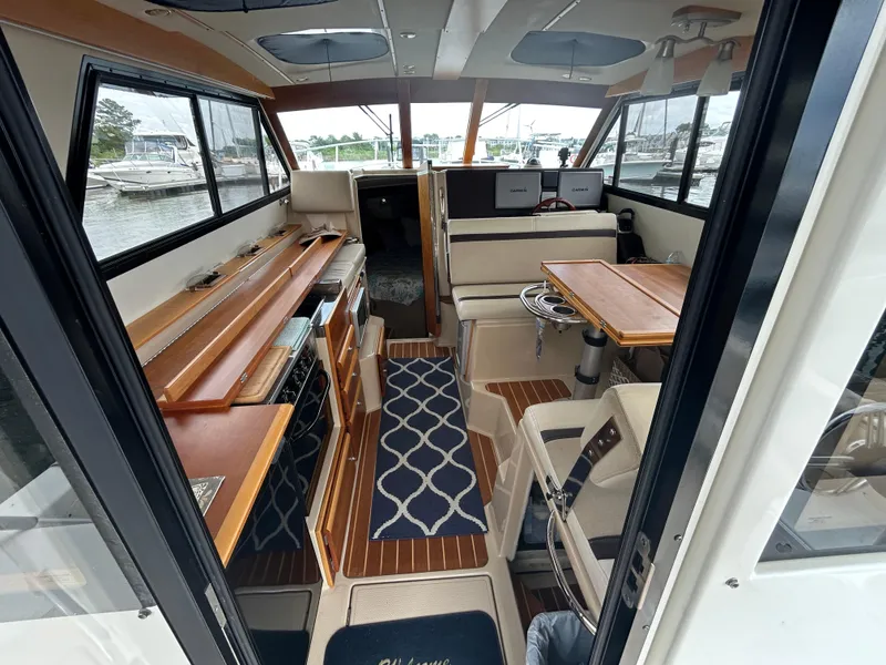 Slide: The Image of Interior of 2014 Cutwater C-30 Sedan boat with wood accents and seating area. - 8