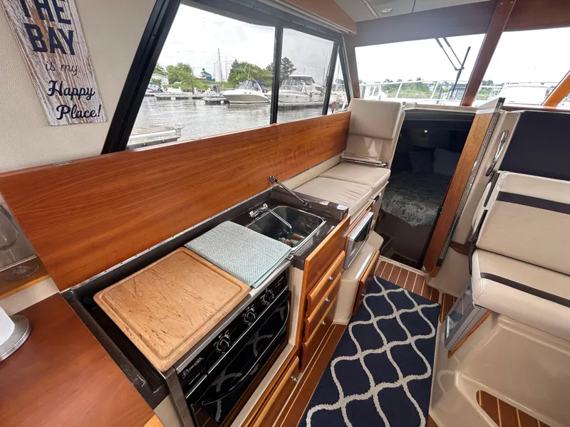 Slide: The Image of Interior of 2014 Cutwater C-30 Sedan boat with kitchen and seating area. - 9