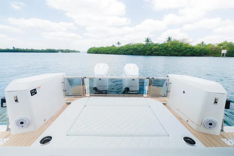 Slide: The Image of 2024 Saxdor 400 GTO boat deck with dual engines on a serene waterway. - 12