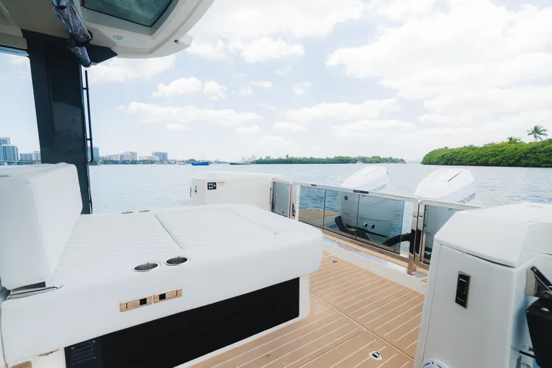 Slide: The Image of 2024 Saxdor 400 GTO boat interior with white seating and scenic water view. - 13
