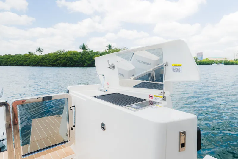 Slide: The Image of 2024 Saxdor 400 GTO boat with sleek design, featuring outdoor kitchen area by the water. - 17