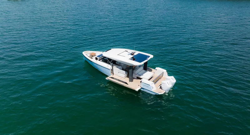 Slide: The Image of 2024 Saxdor 400 GTO boat cruising on clear blue water. - 2