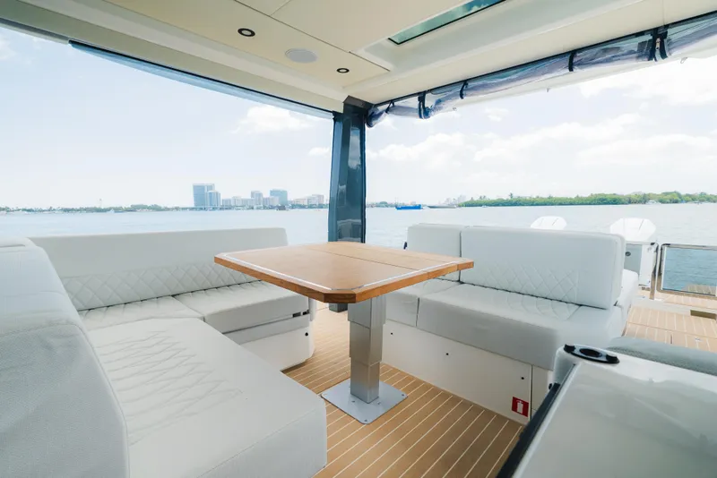 Slide: The Image of 2024 Saxdor 400 GTO interior with modern seating and table, overlooking a scenic waterfront. - 20